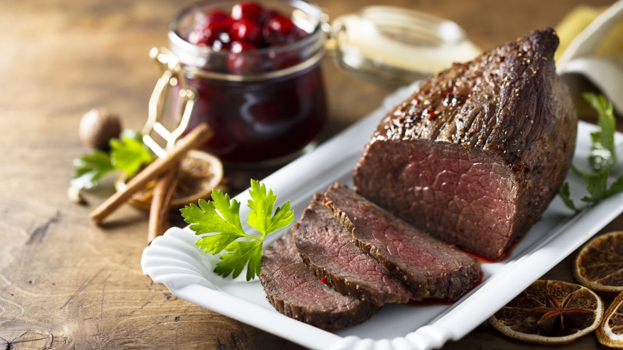 Sliced rosemary roast beef with cranberry glaze