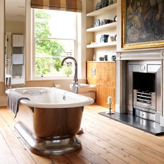 bathroom with bathtub window and wooden floor