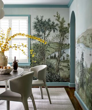 dining room with tree mural and white dining chairs