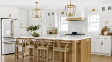 A modern farmhouse kitchen in light wood and white with kitchen island