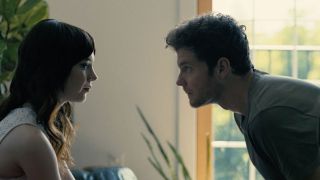 sophie thatcher and jack quaid look into each others eyes in companion