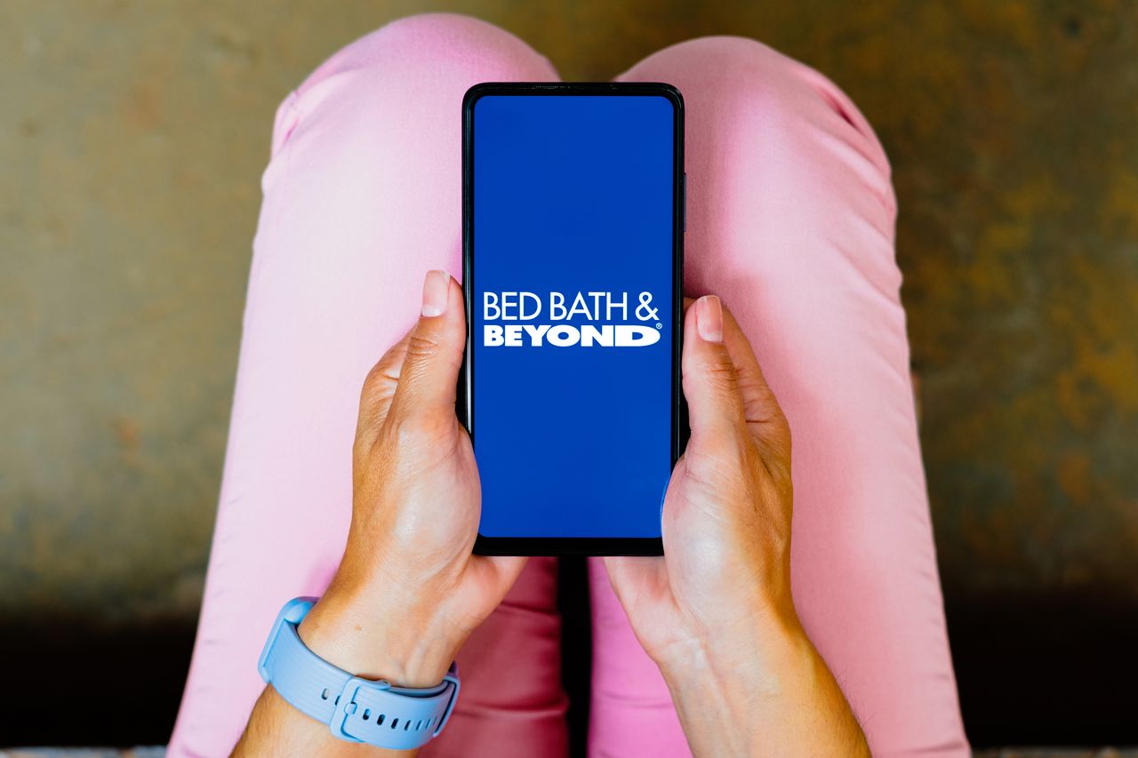 A phone screen with the Bed Bath &amp;amp; Beyond logo in white and blue