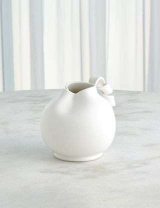 white hand-crafted pitcher on a marble surface