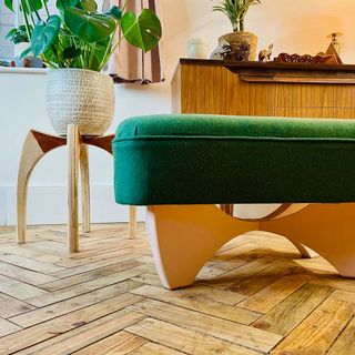 after view of wooden floor renovation with green foot stool with wooden legs