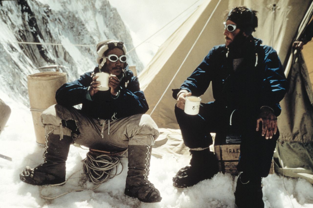 Two men in 1950 climbing kit drinking tea on Mount Everest 