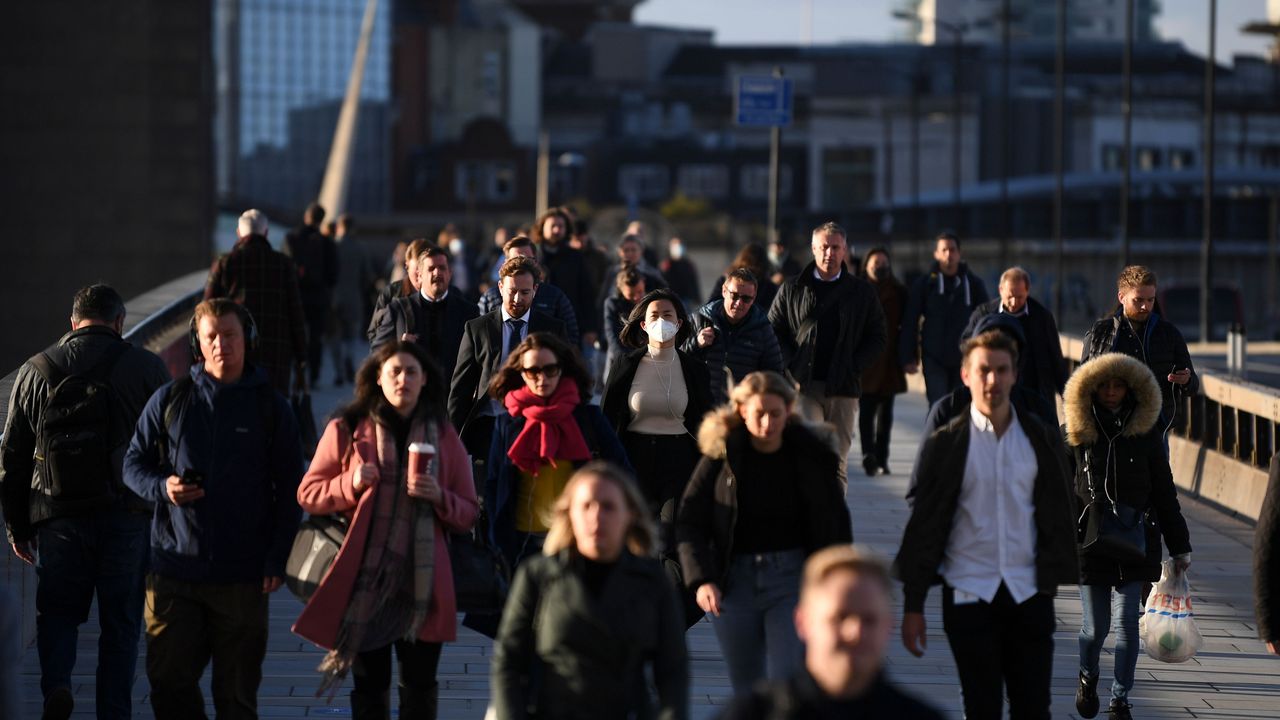 Commuters cross London Bridge this morning.