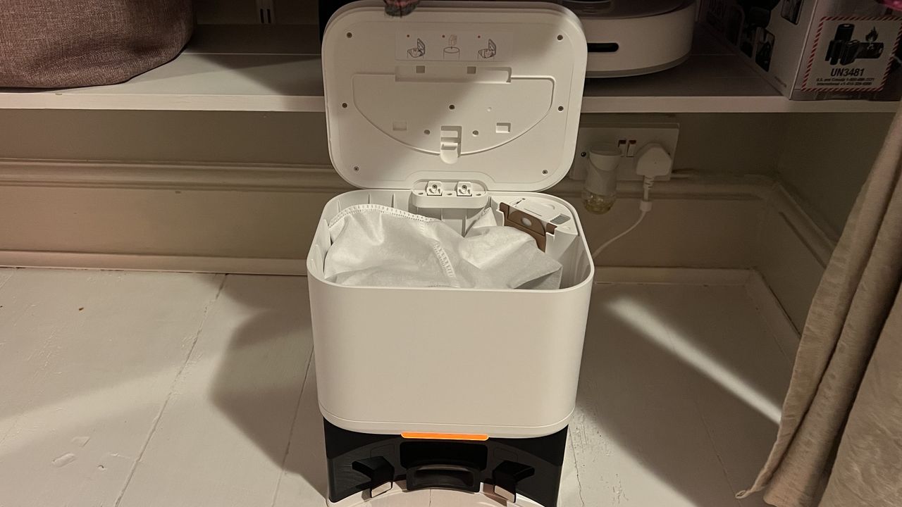 The auto empty station opens to reveal a 4 litre bin with a bag to collect dust