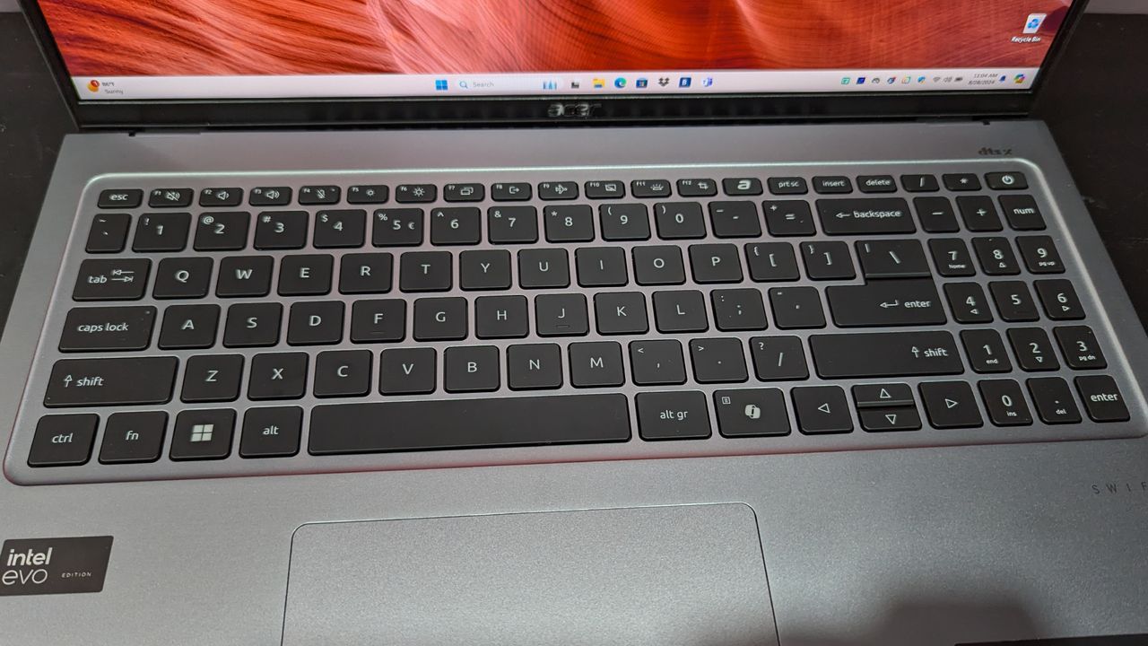 A close up of the black keyboard on gray laptop.