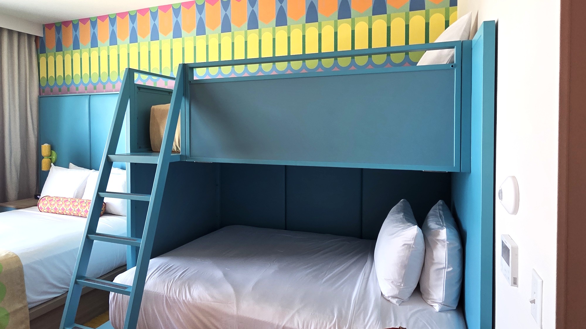 The bunk beds are shown in a Universal Kids Resort Deluxe Queen room.