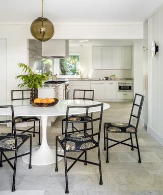 white kitchen diner with tulip table in mid-century style