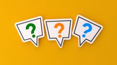 three multi-colored question marks in speech bubbles against a bright orange background