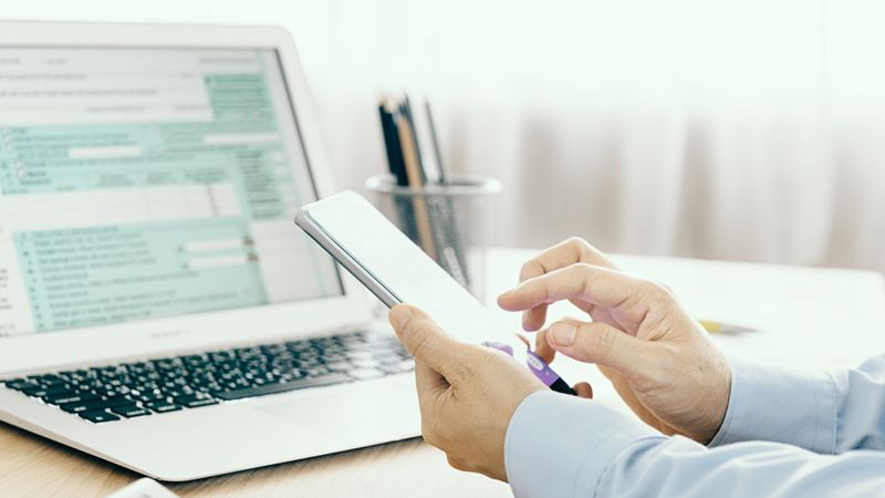 man at desk with laptop taxes