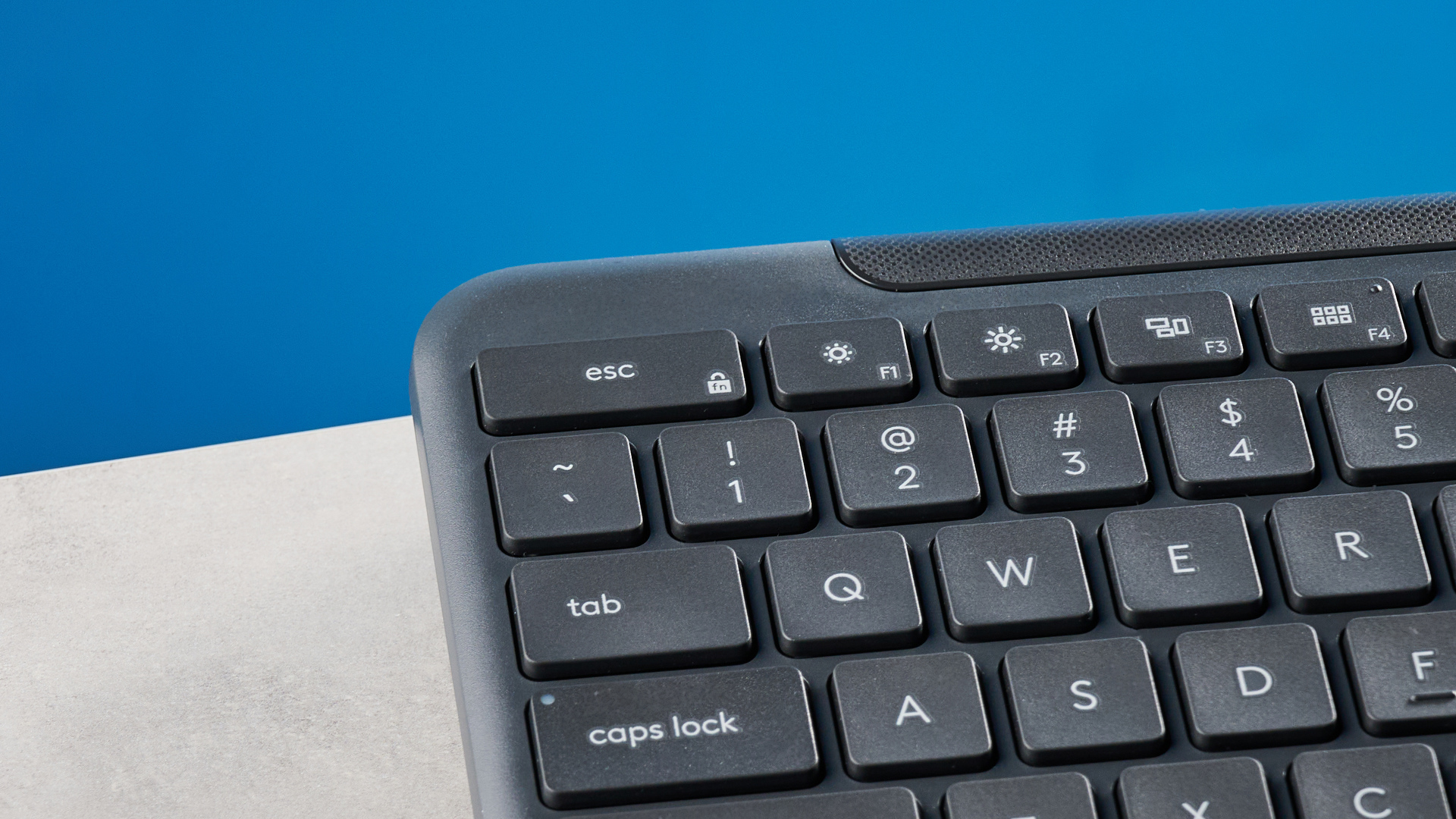 The Logitech K620 keyboard in a graphite grey colorway photographed as part of the MK625 como on able and white background.