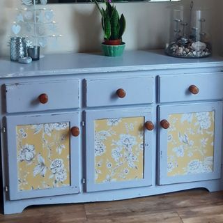 room with floral printed wooden dresser