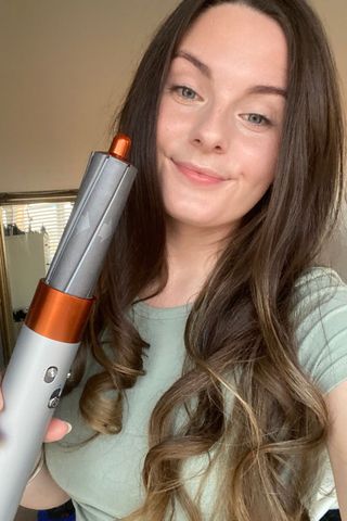 How to use Dyson Airwrap - picture of tori crowther with curled hair holding the dyson airwrap