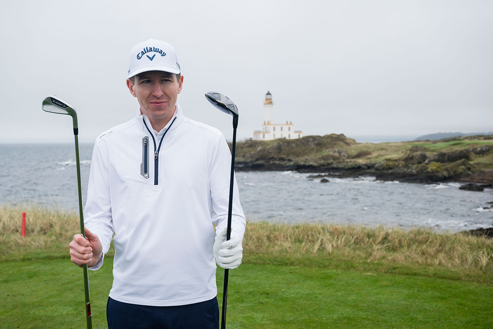 Ben Emerson looking at a fairway wood and a long iron, deciding which to hit in challenging conditions after calculating his distance in the wind
