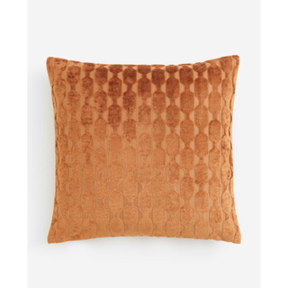 orange velvet pillow cover with a geometric pattern