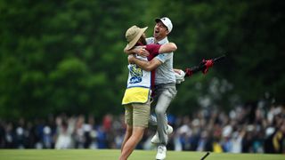 Nick Taylor of Canada celebrates with his caddie after making an eagle putt on the 4th playoff hole to win the RBC Canadian Open