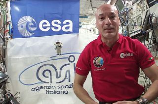 Expedition 61 commander Luca Parmitano of the European Space Agency (ESA) floats alongside a Playmobil toy figure created in his likeness on board the International Space Station.