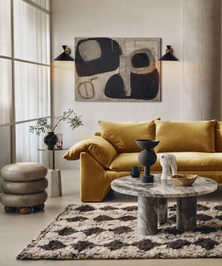 Living room designed by Soho home with large yellow sofa
