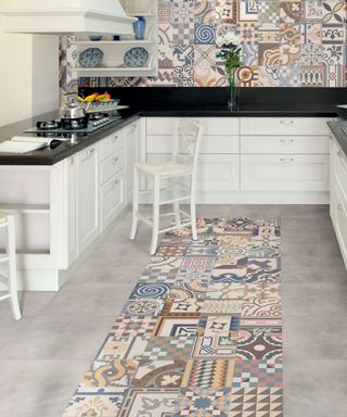 patterned tile runner in a white kitchen with shaker cabinets open shelving and grey tiles