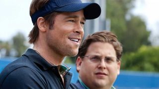 Brad Pitt and Jonah Hill stand on the field in Moneyball.