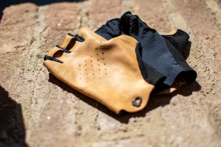 A pair of Pearl Izumi Pro Air mitts on a brick wall