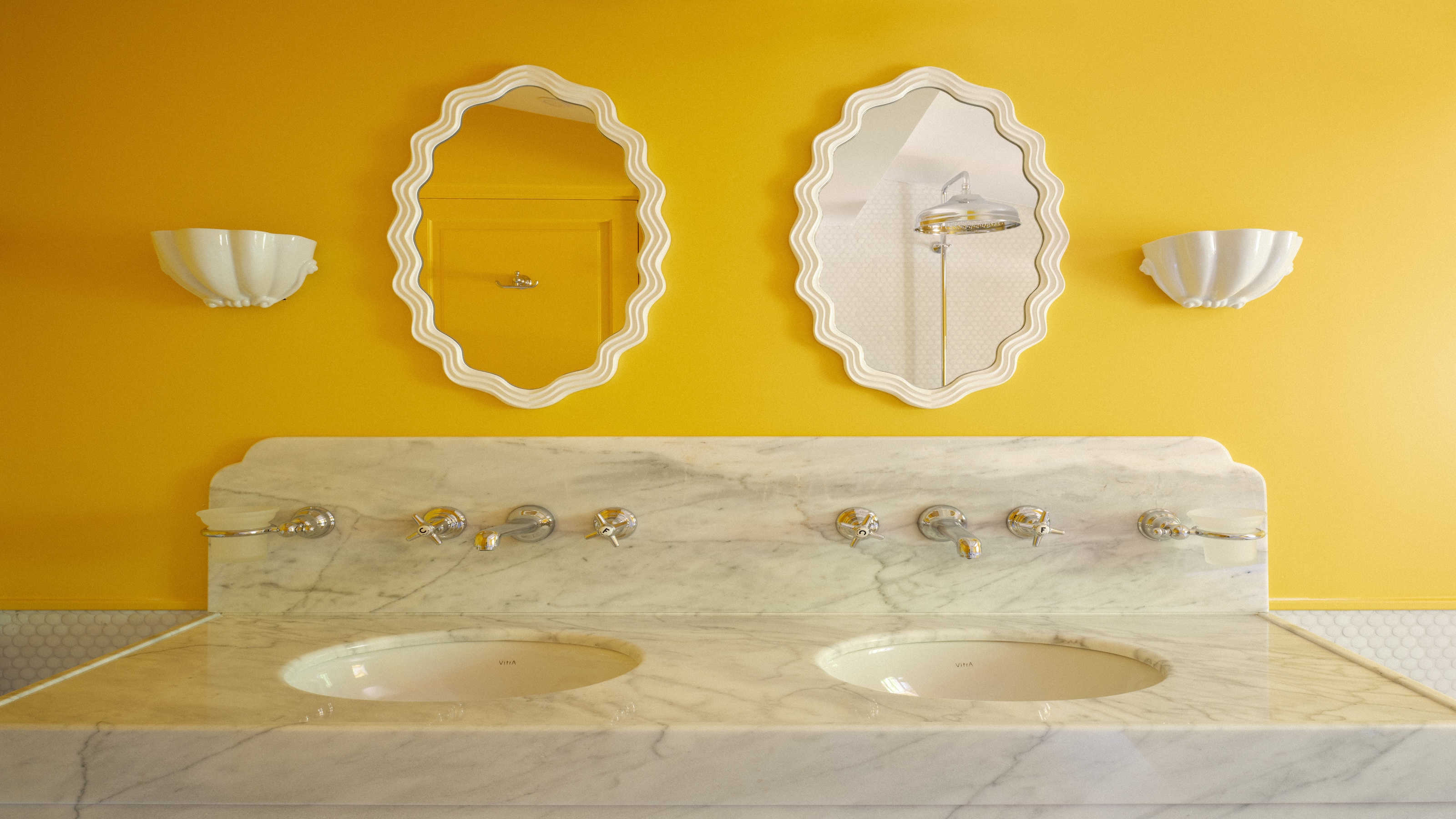 A double mirror and double marble sink in a yellow bathroom