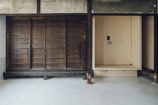 Entrance door crafted with timber at the Suzu apartment building renovation