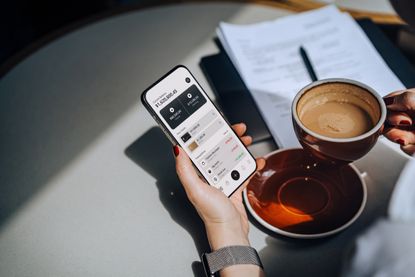 Cropped shot of a woman accessing online banking with mobile app