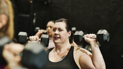 Woman lifting weights at a CrossFit session
