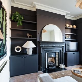 living room with black painted storage and fireplace
