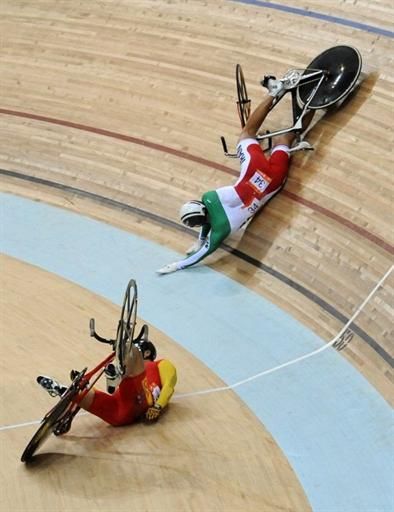 Lei Zhang (China), left, and Mohammad Parash (Iran) crashed during the men's keirin final.
