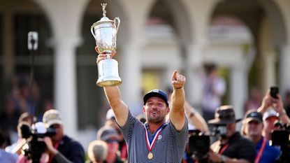 Bryson DeChambeau holds up the US Open trophy