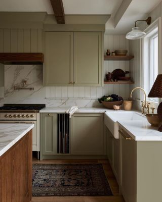 a dark beige kitchen with cutting board storage