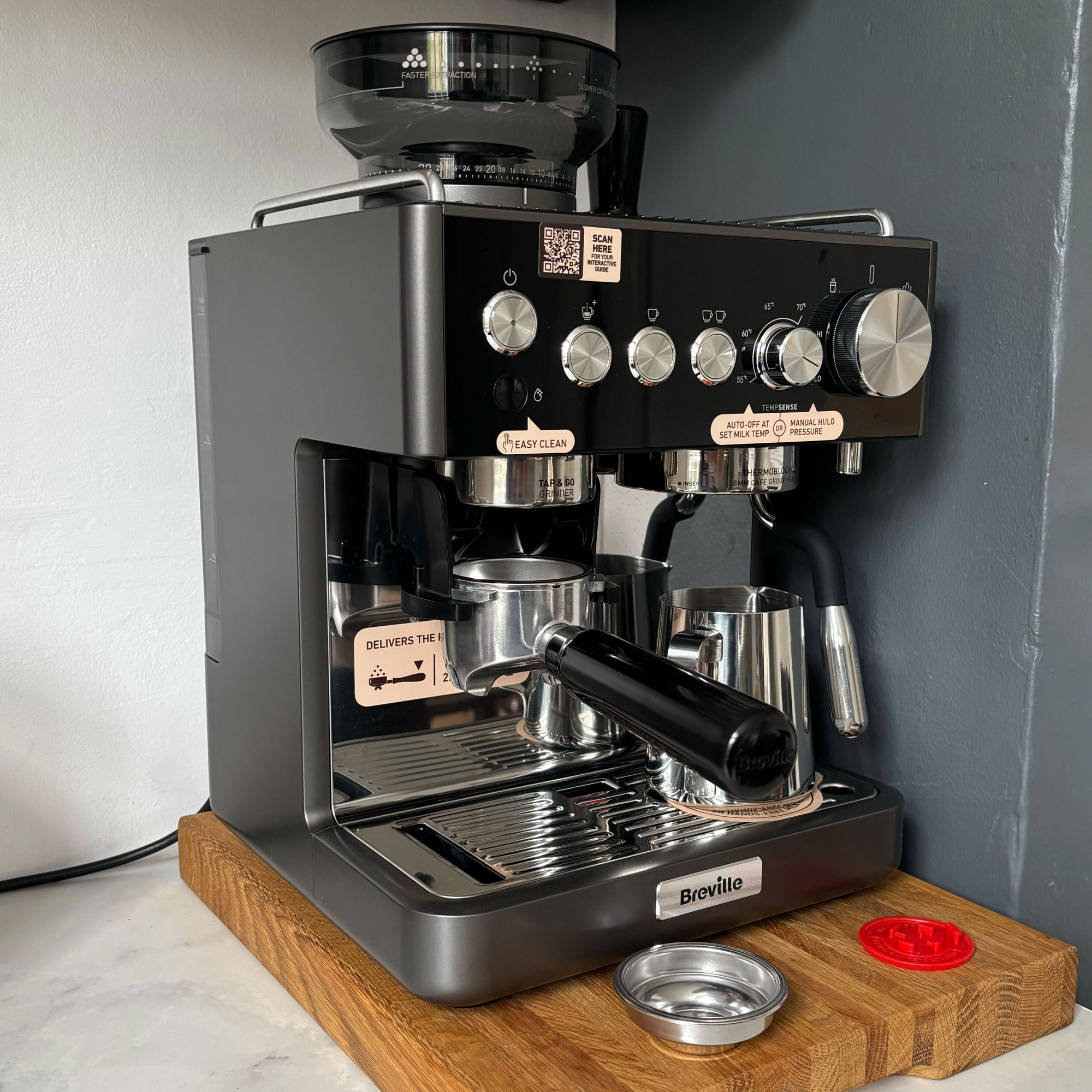Breville coffee machine from the side on, on a wooden chopping board