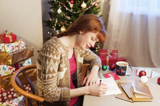 Woman writing Christmas cards