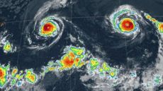 A radar weather map showing two hurricanes that look like the eyes in a multicolor smiley face