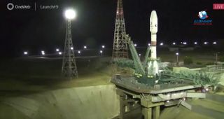 An Arianespace Soyuz rocket topped with 34 OneWeb internet satellites sits on the pad at Baikonur Cosmodrome shortly before a planned liftoff on Aug. 19, 2021. The launch was aborted late in the countdown clock.