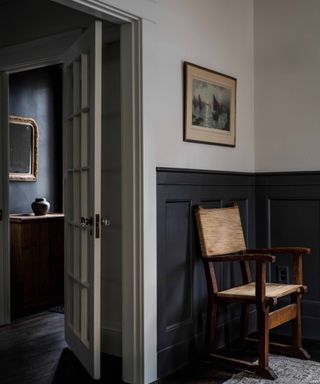 Entryway with half paneling painted in dark gray