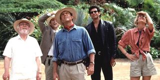 John Hammond, Alan Grant, Ian Malcolm and Ellie Sattler look up at an off-screen dinosaur in 'Jurassic Park'