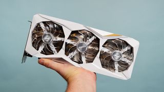 An ASRock Steel Series Radeon RX 7900 GRE being held in a man's hand.