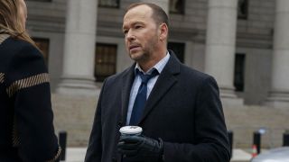 Donnie Wahlberg as Danny Reagan in Blue Bloods holding a cup of coffee.