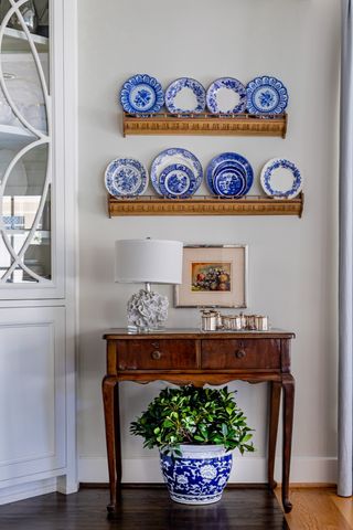 Hallway sideboard with plates used as wall decor