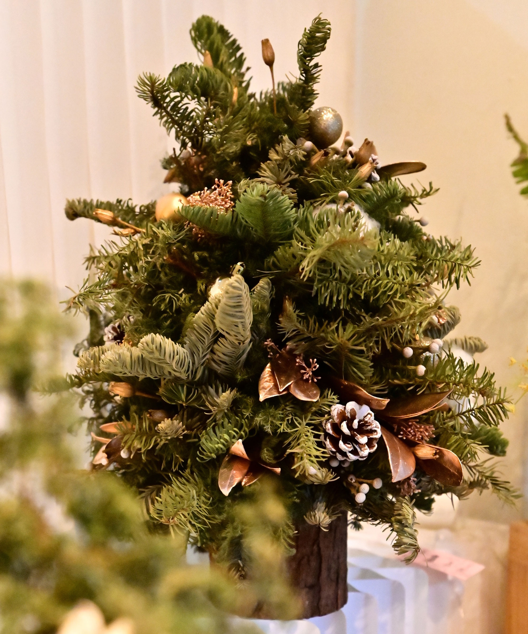 mini Christmas tree with pine cones and festive trim
