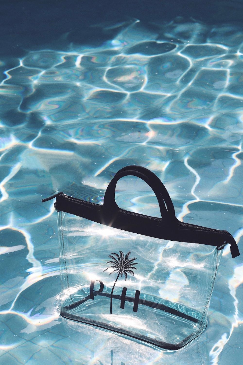 a palm heights bag floating in a pool