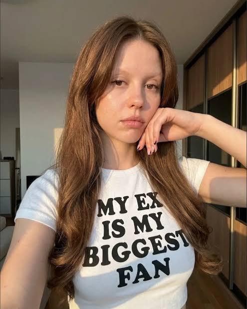 Ai image of Mia Goth wearing a t shirt reading "MY EX IS MY BIGGEST FAN"