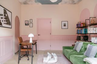 A living room with half painted walls and clouds