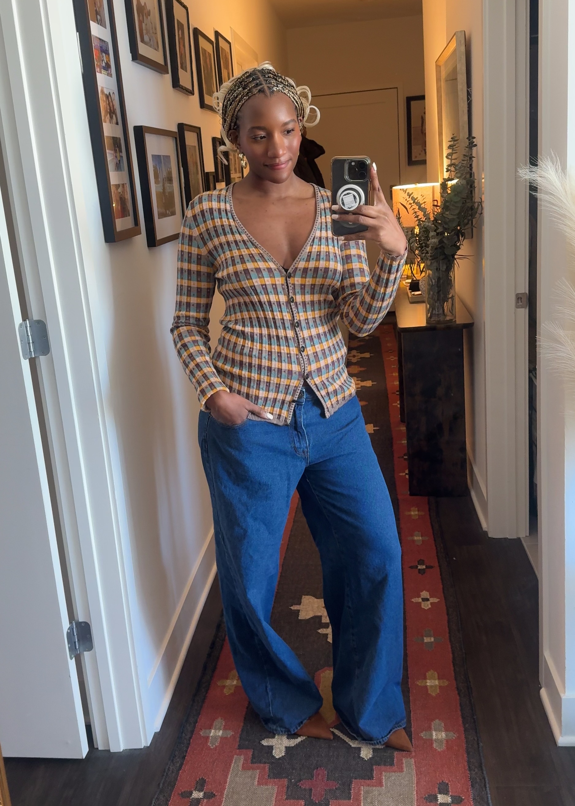 Danielle Prescod wearing a vibrant cardigan, jeans, and heels