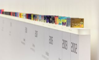a 'history wall': a display where visitors can see the 102 card plates produced by the company since its launch
